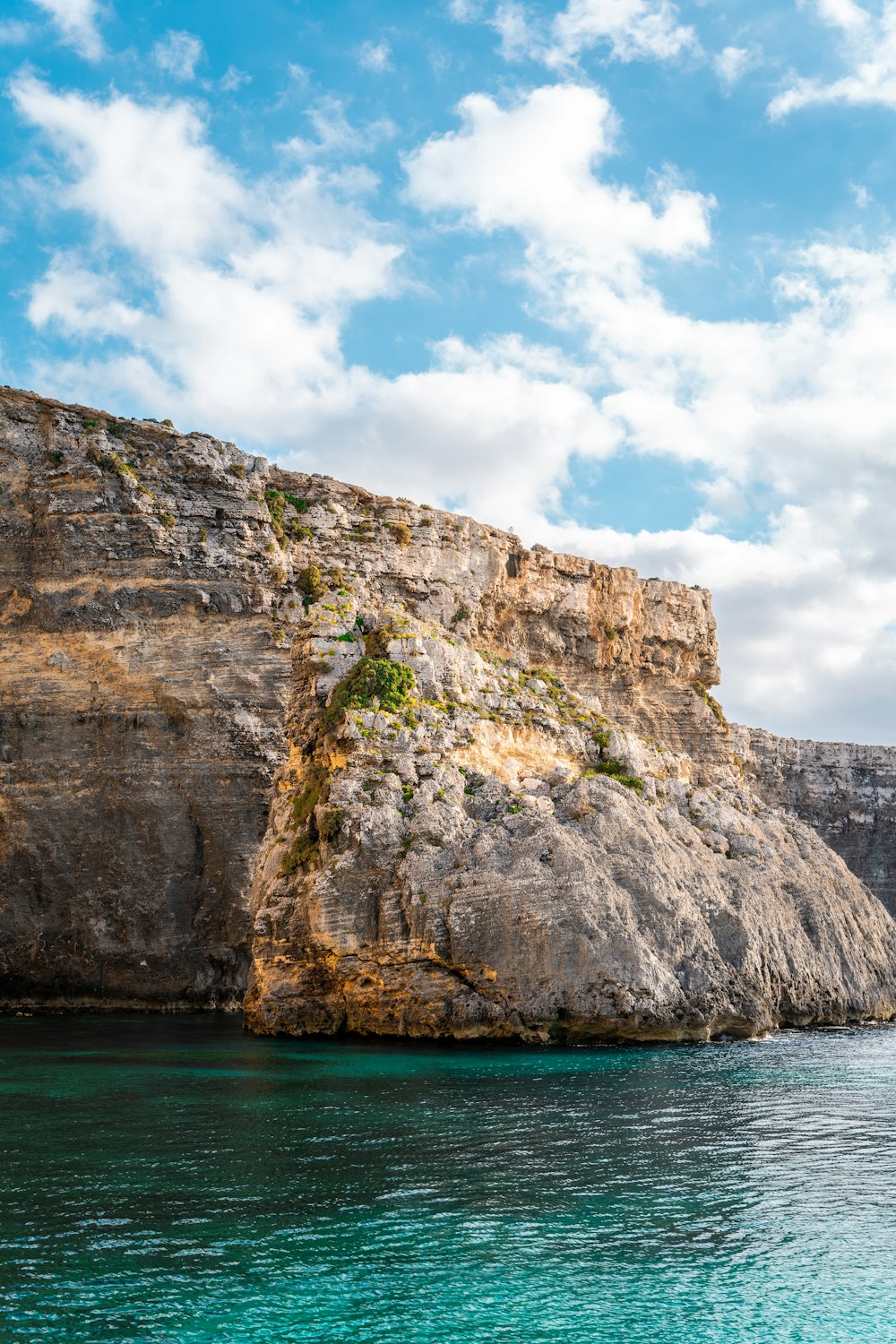 a large rock outcropping next to a body of water