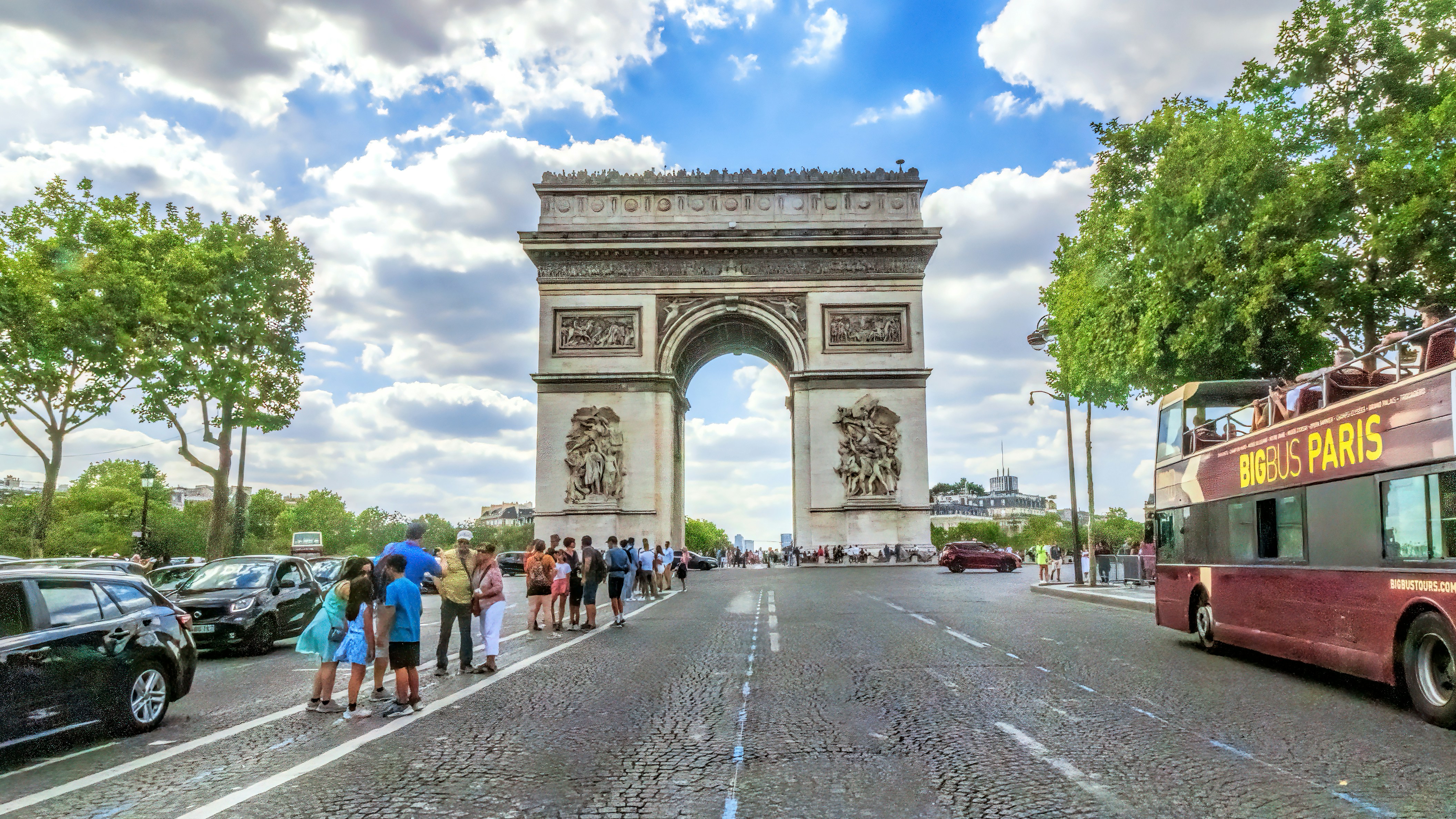 a group of people standing on the side of a street