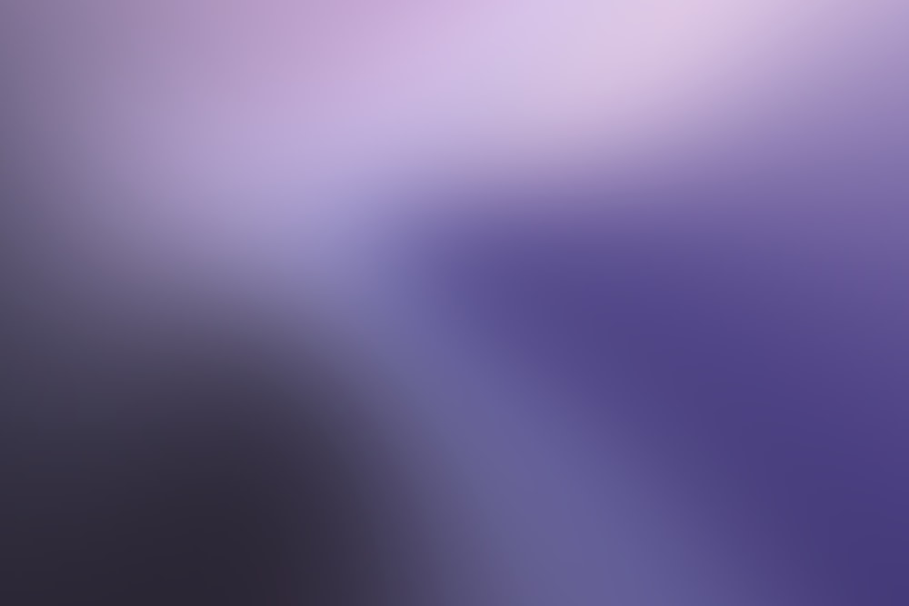 a blurry image of a purple and white background