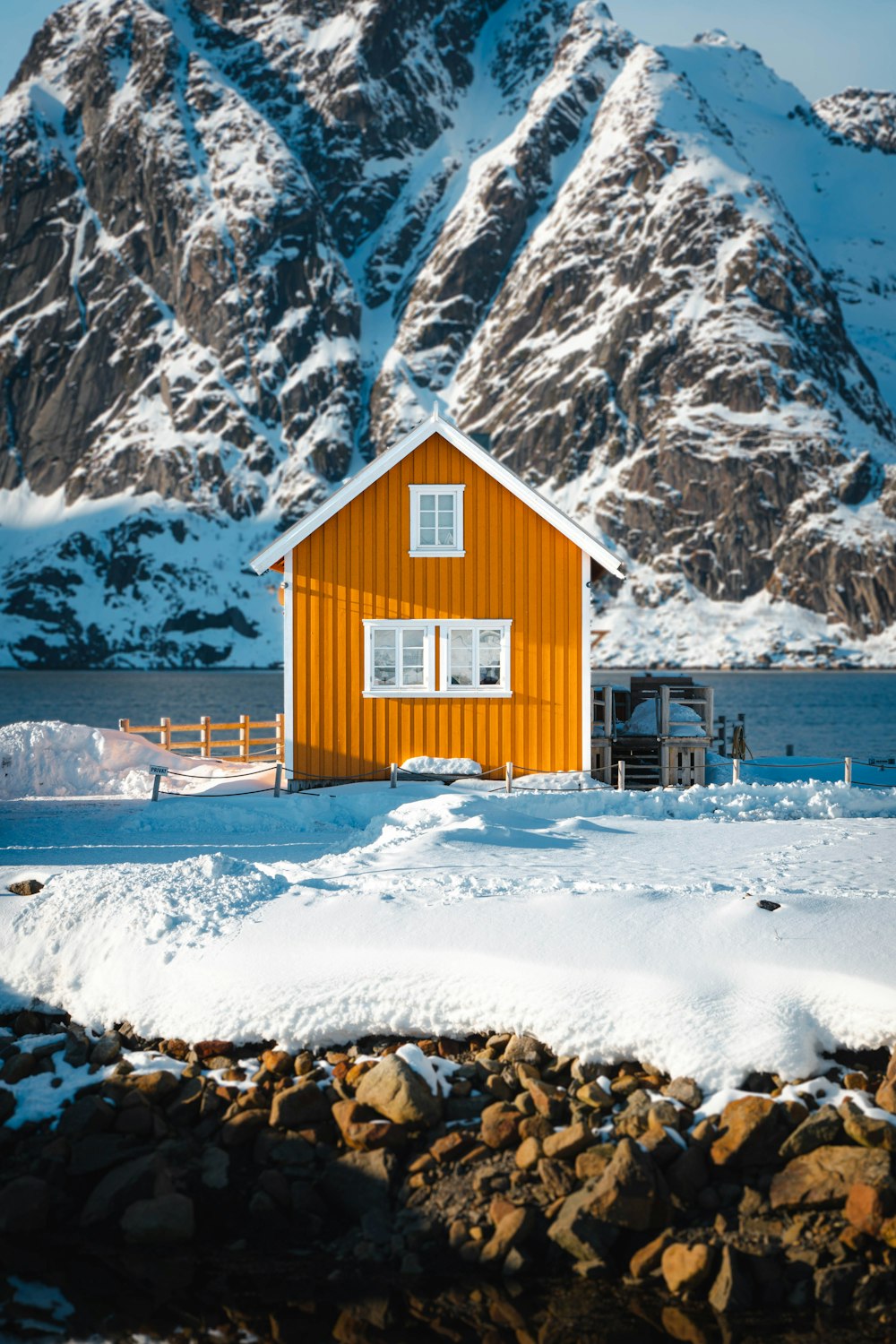 a red house with a mountain in the background