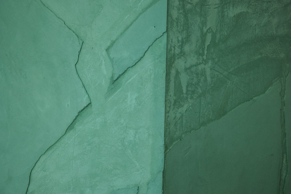 a close up of a wall with green paint