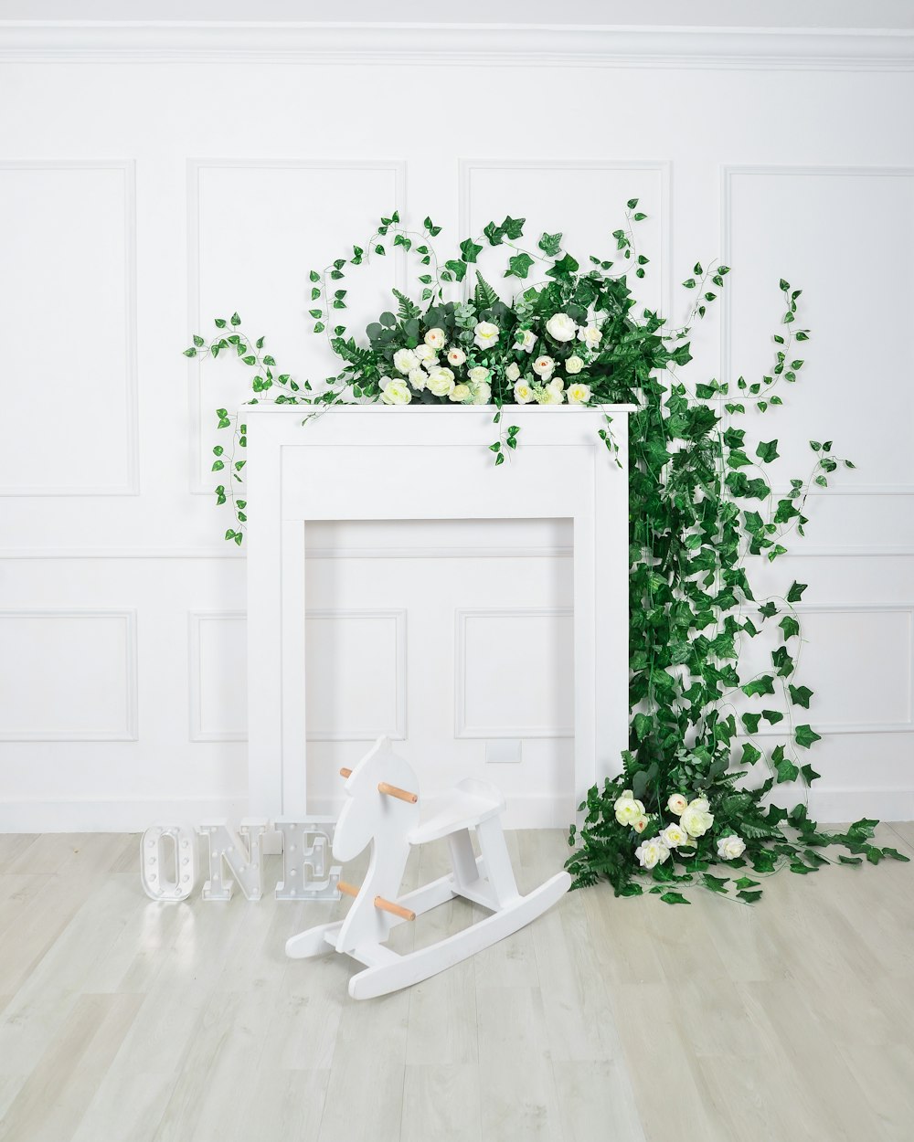 a white rocking horse next to a white fireplace