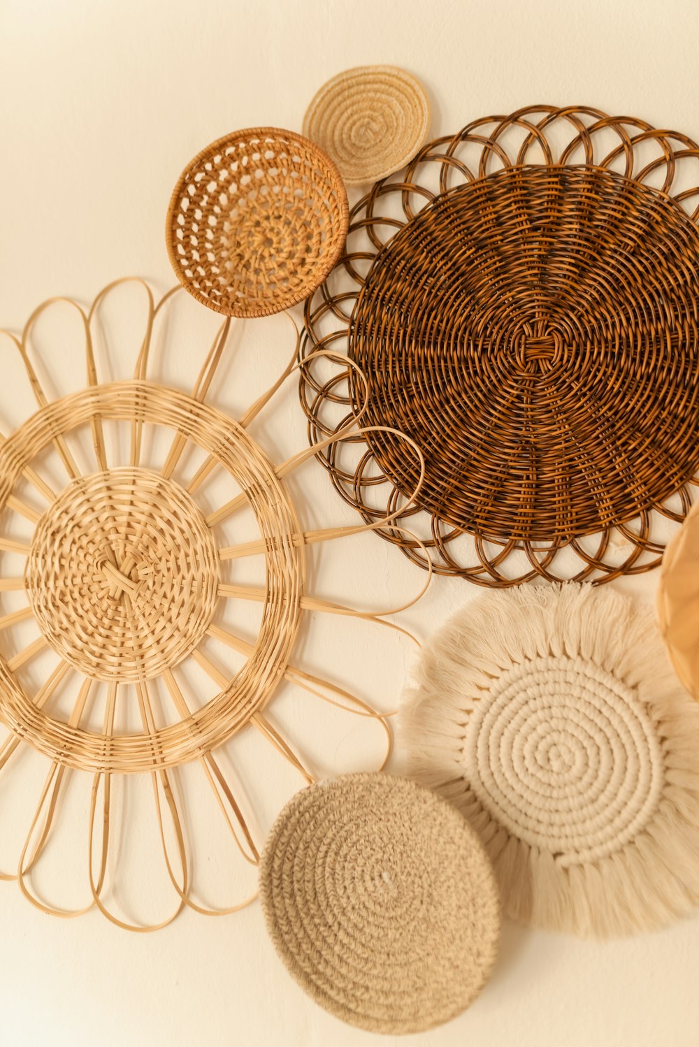 a group of woven baskets hanging on a wall