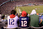 A passionate football fan wearing a vintage-style jersey, cheering in a stadium.