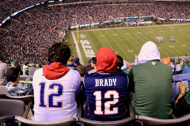 A dynamic photo of a fan wearing a new football jersey, cheering in a stadium.