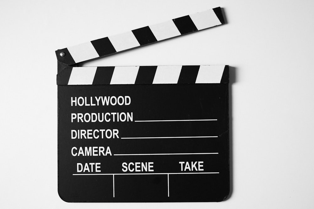 a black and white movie clapper on a white background