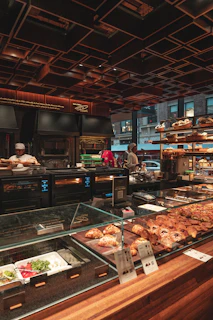 A warm, rustic bakery counter with fresh conchas and pan de yema displayed invitingly.