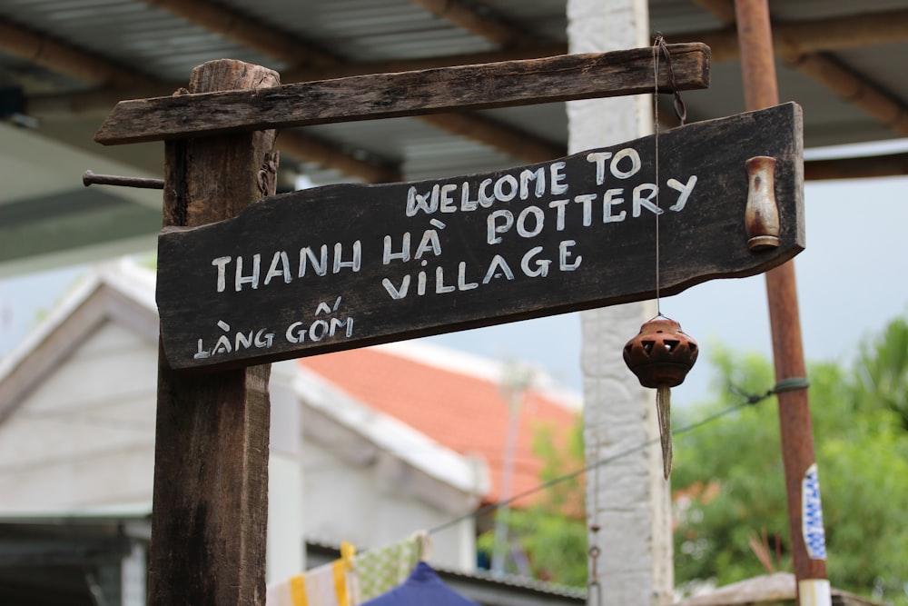 a welcome sign for a village in thailand