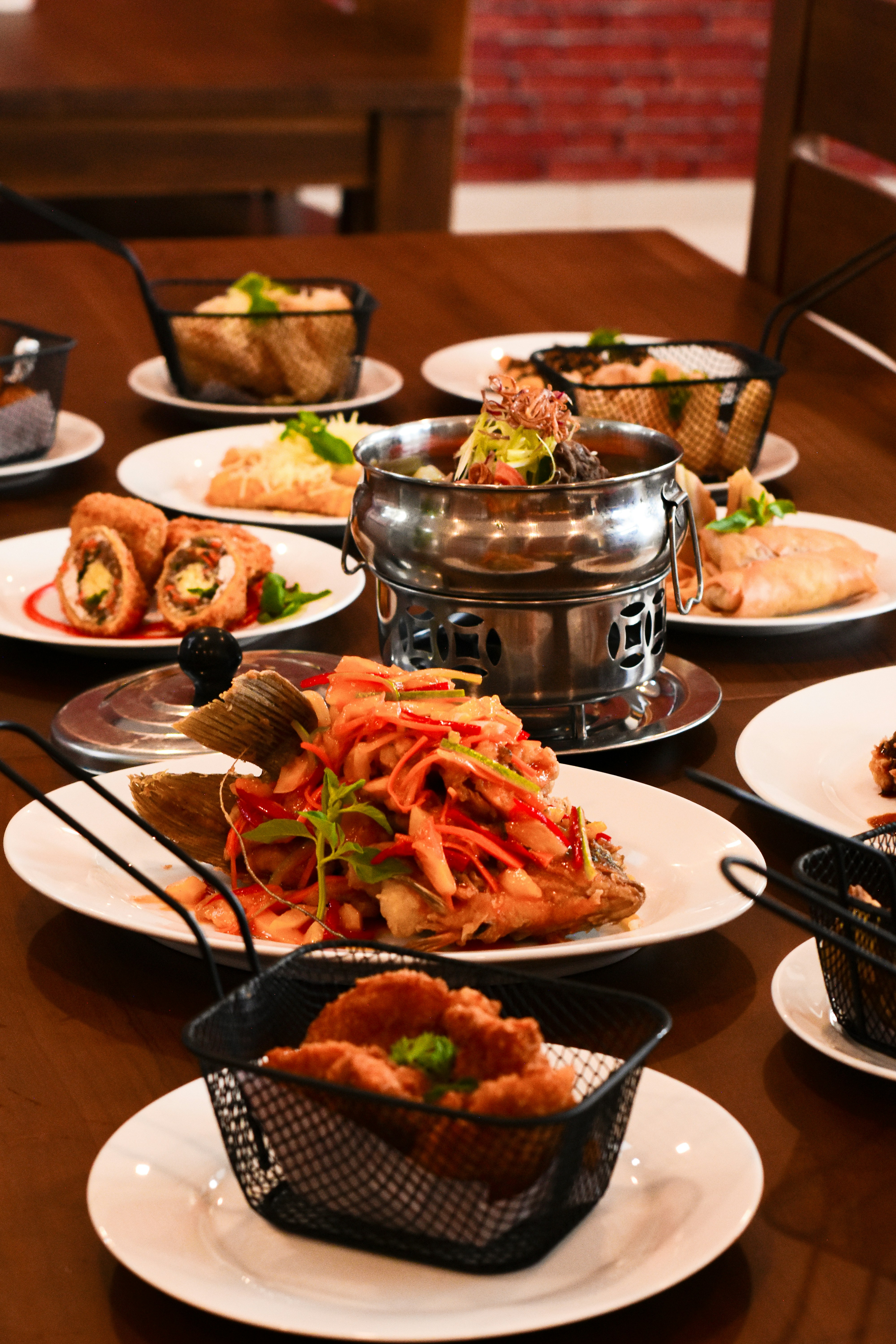 a wooden table topped with plates of food