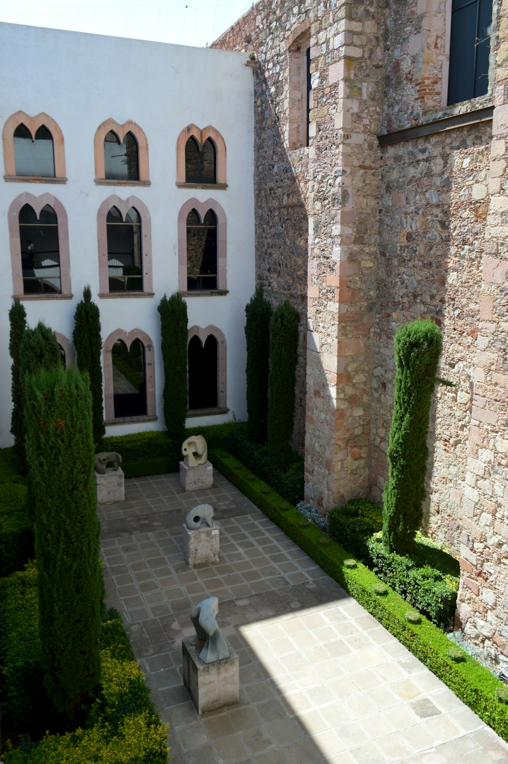 the courtyard of a building with a stone walkway