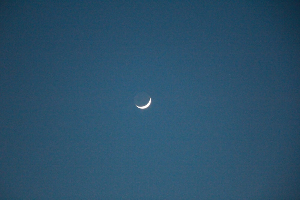 a half moon is seen in the sky