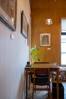 A cozy kitchen corner featuring a natural oak dining table with matching chairs bathed in warm light