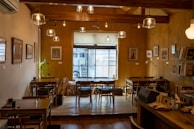 A cozy coffee shop interior with warm lighting and wooden furniture.