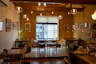 Cozy urban cafe interior with warm lighting and creative design details.