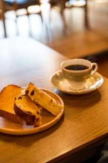 An inviting shot of a breakfast table featuring toast with honey and a fresh coffee cup