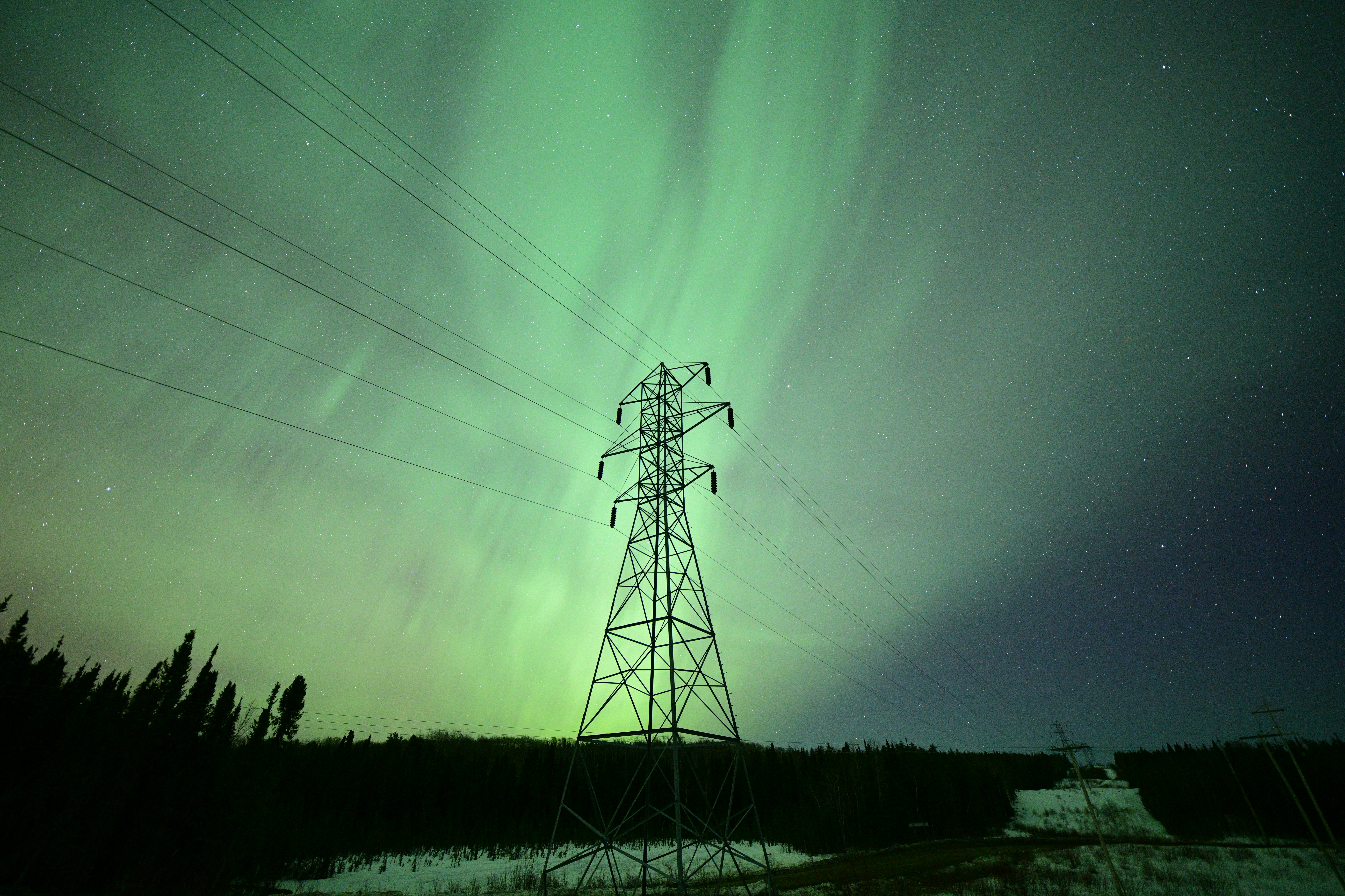 a tall tower sitting under a green sky