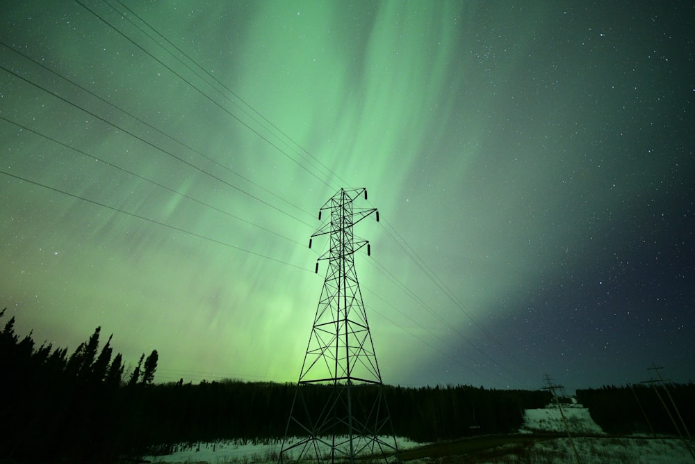 a tall tower sitting under a green sky