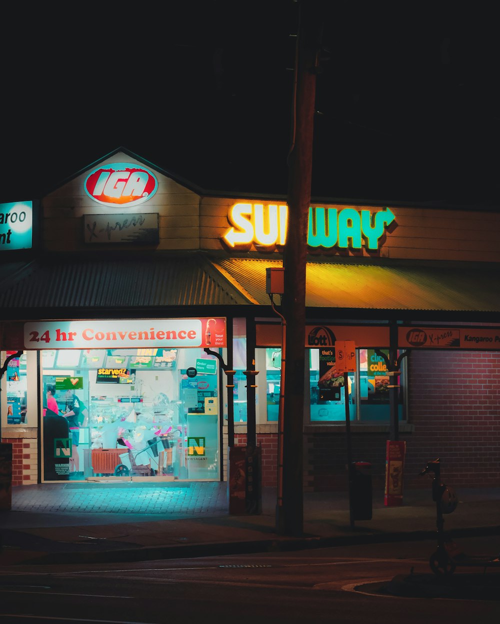 a store front at night with neon lights