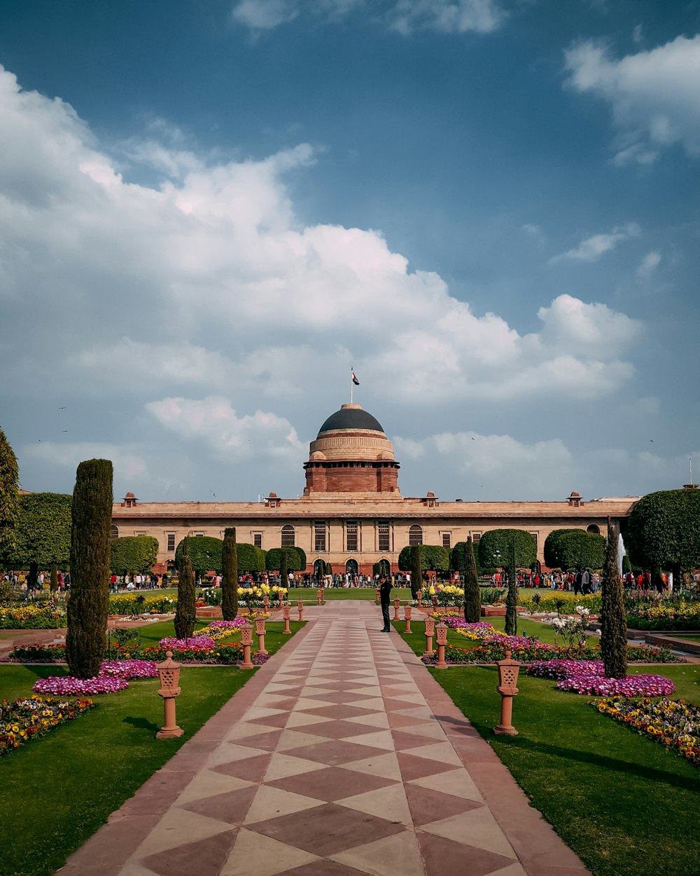 a large building with a checkered walkway in front of it