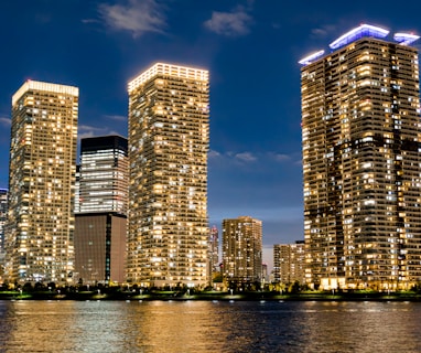 a group of tall buildings next to a body of water