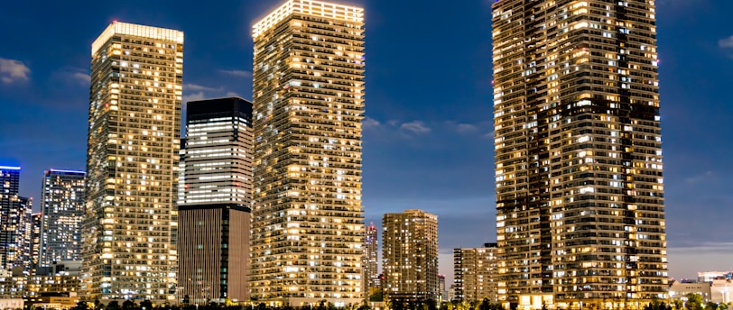 a group of tall buildings next to a body of water