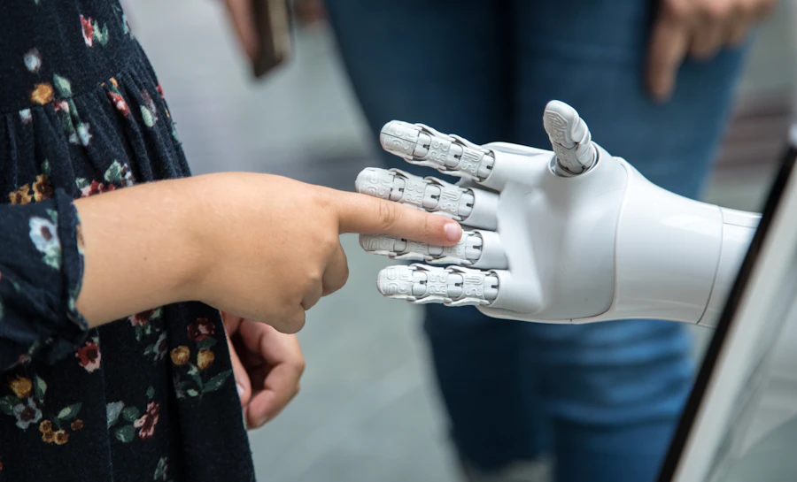 Close-up of a hand reaching toward a white robotic hand