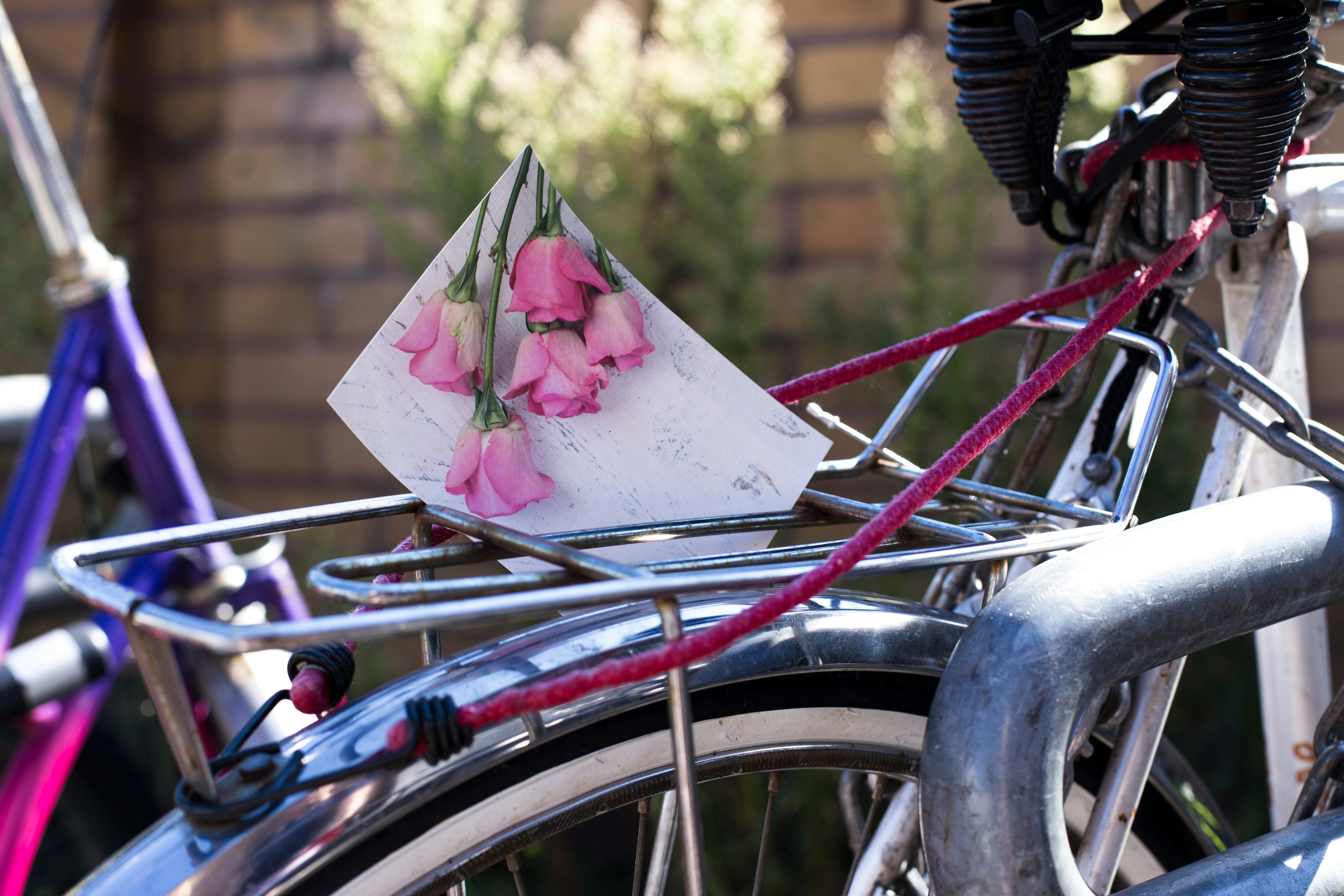 a close up of a bicycle with flowers on it