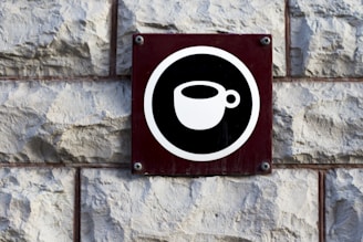 a black and white sign on a brick wall