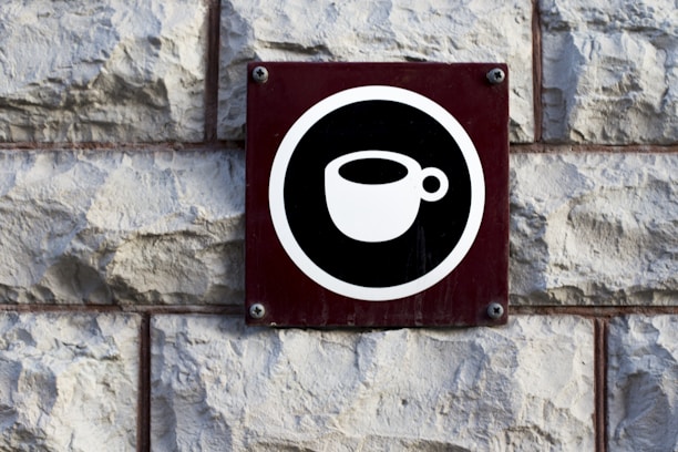 a black and white sign on a brick wall