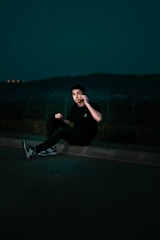 Friendly trip coordinator assisting a traveler via phone at night.