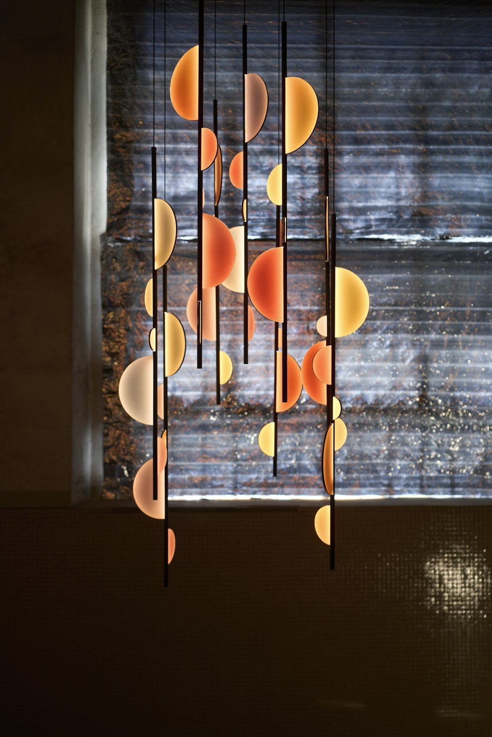 a chandelier hanging from a ceiling in front of a window