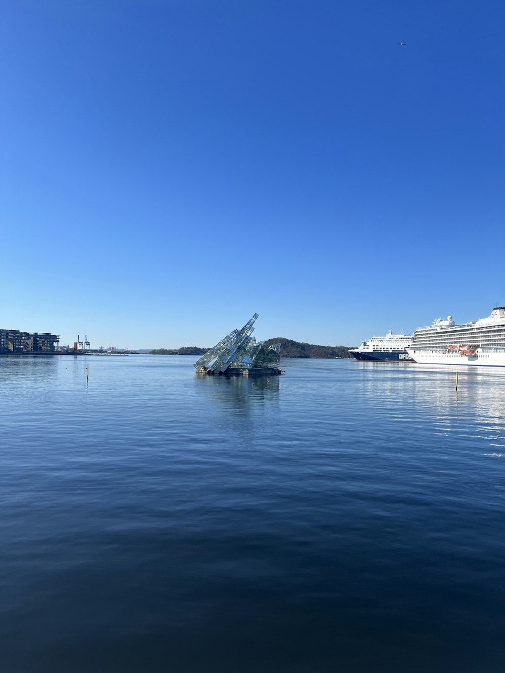 a large body of water with a cruise ship in the background