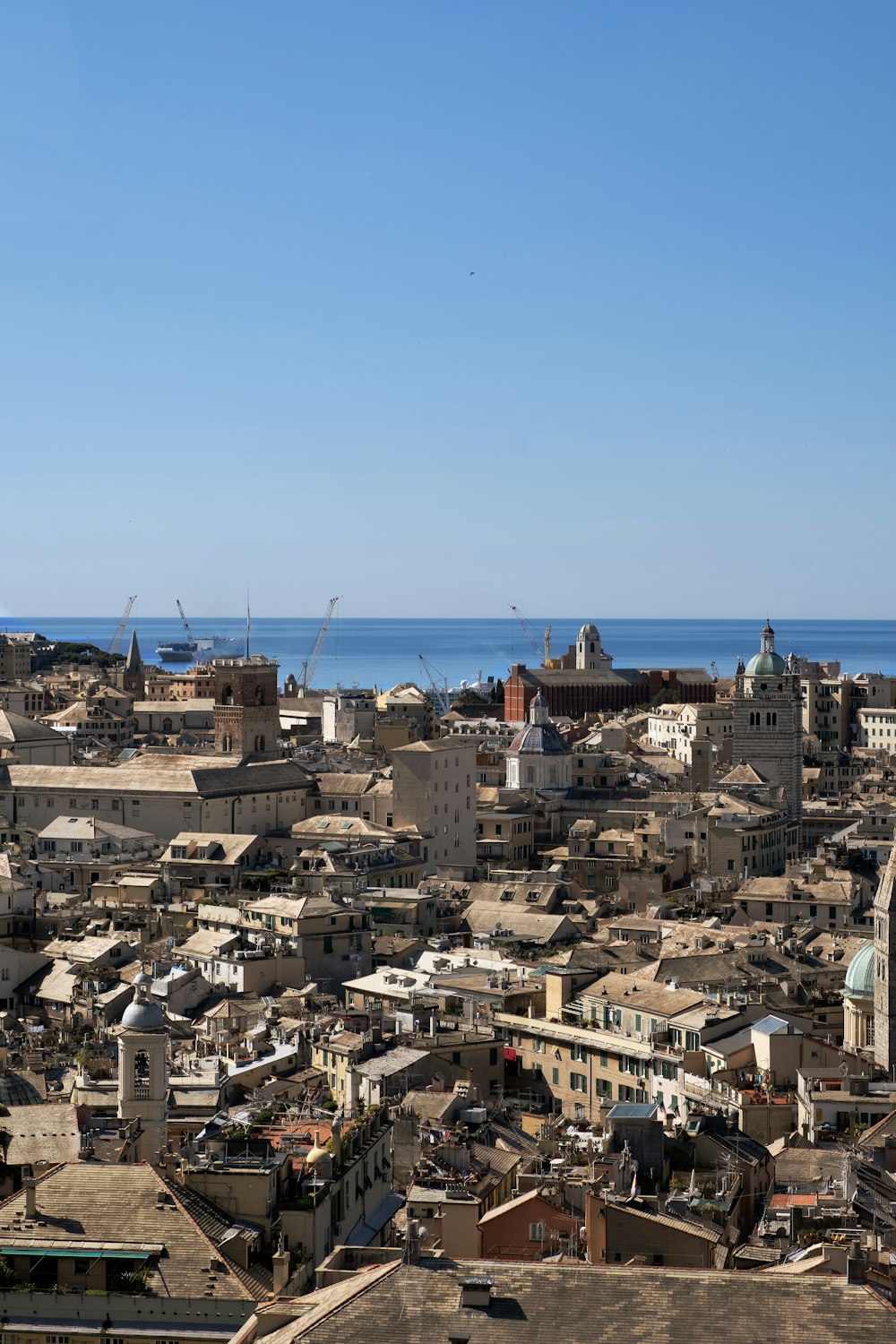 a view of a city with a body of water in the background