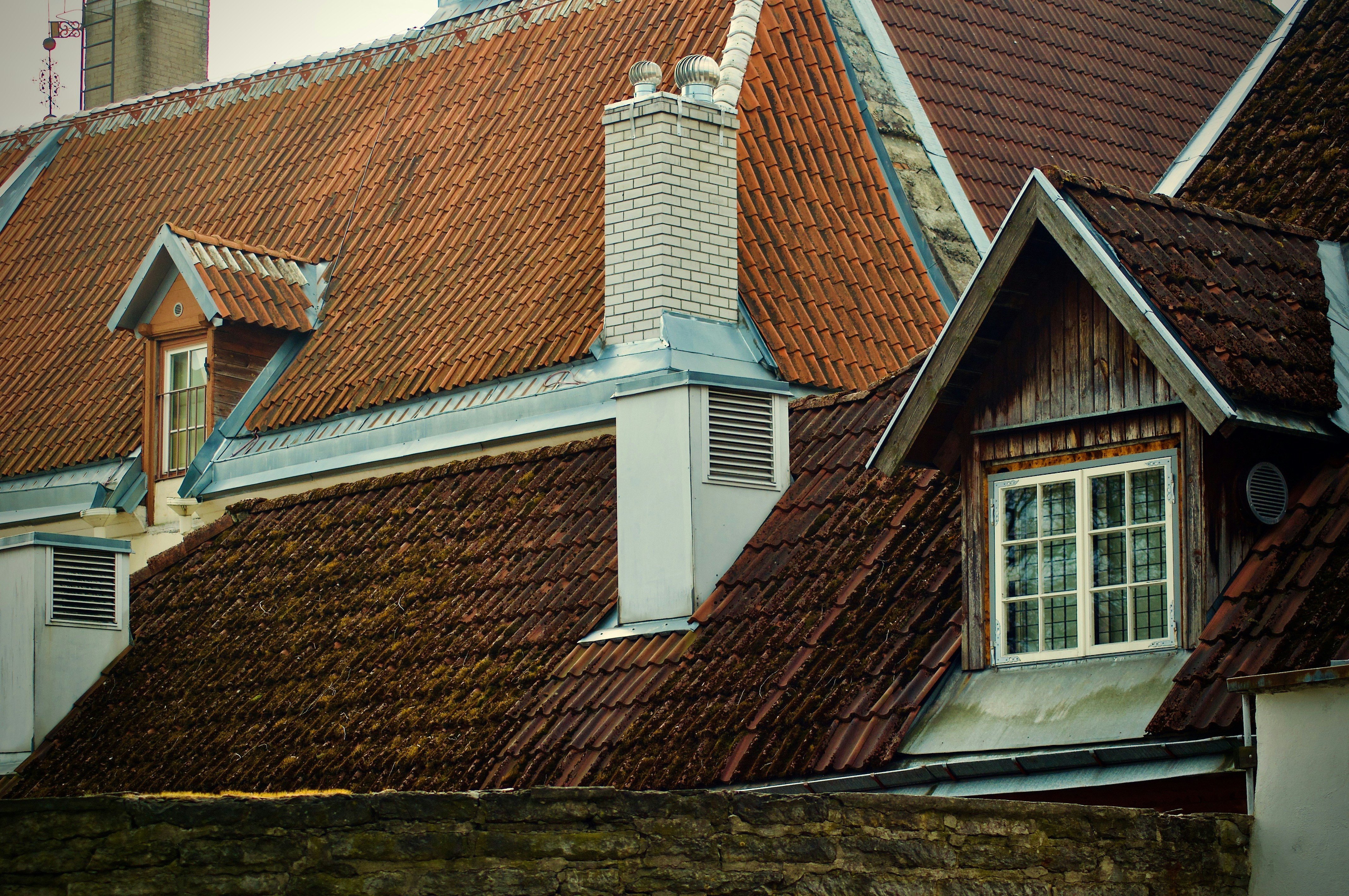a row of houses with red tiled roofs, Roof tops of Tallinn old town.