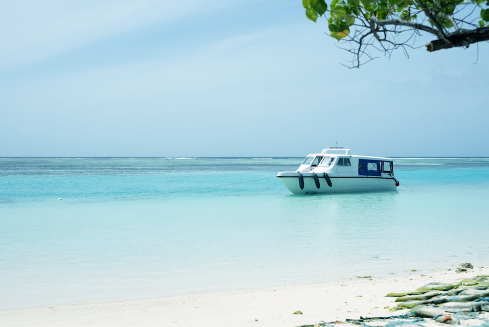 a small boat floating on top of a body of water