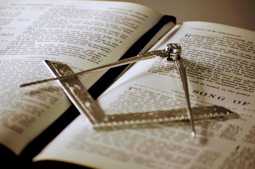 Close-up of a finely embroidered Masonic apron laid out on a wooden table.