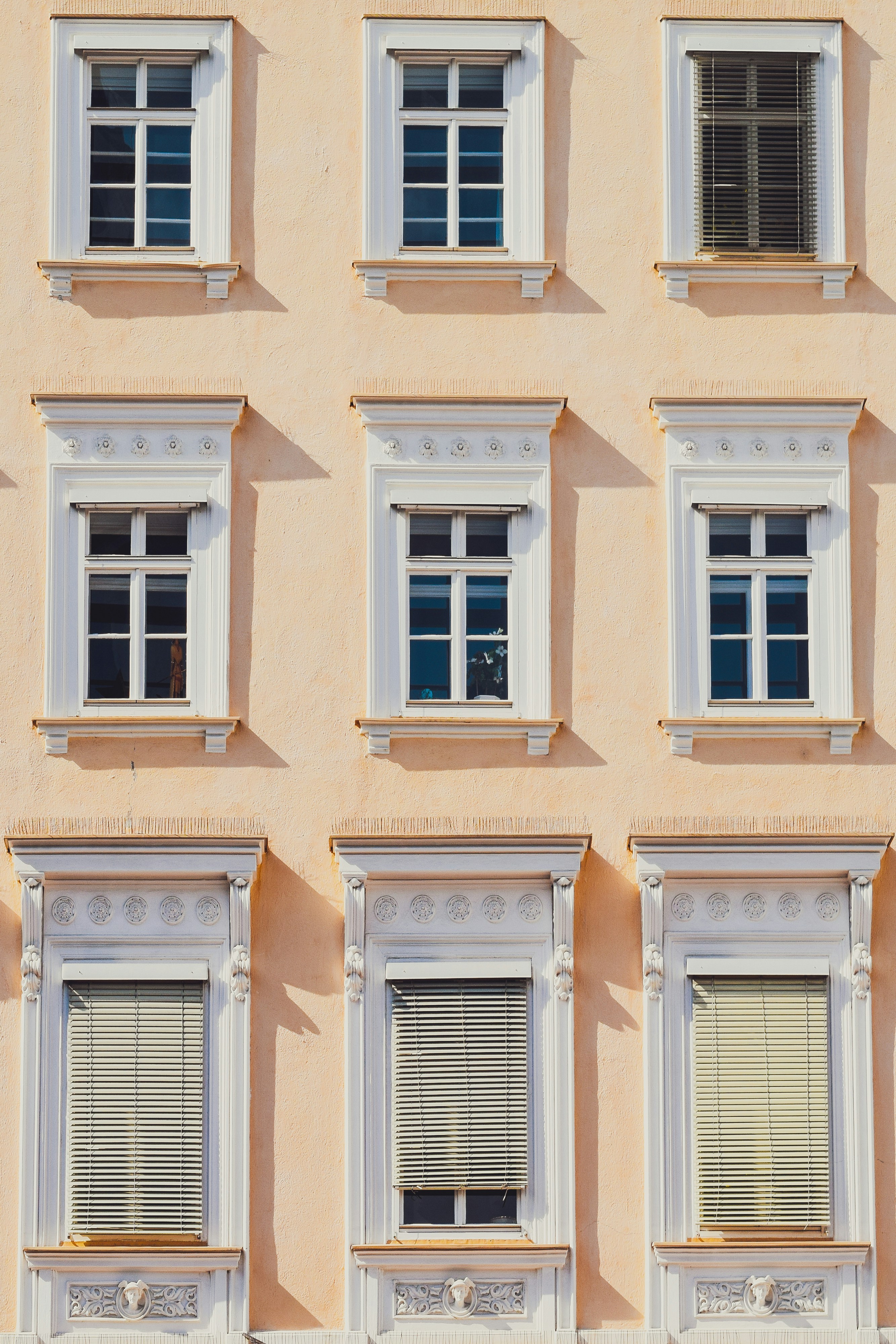 a building with many windows and a clock on the front of it