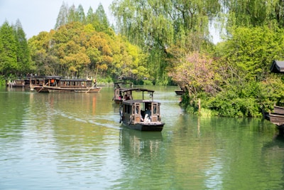 Traditional wooden boats gliding through the calm waters of Tam Coc in Ninh Binh