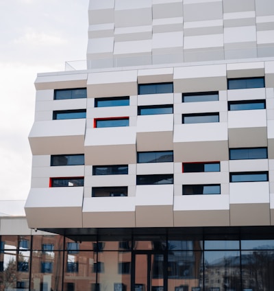 a tall white building with many windows on the side of it