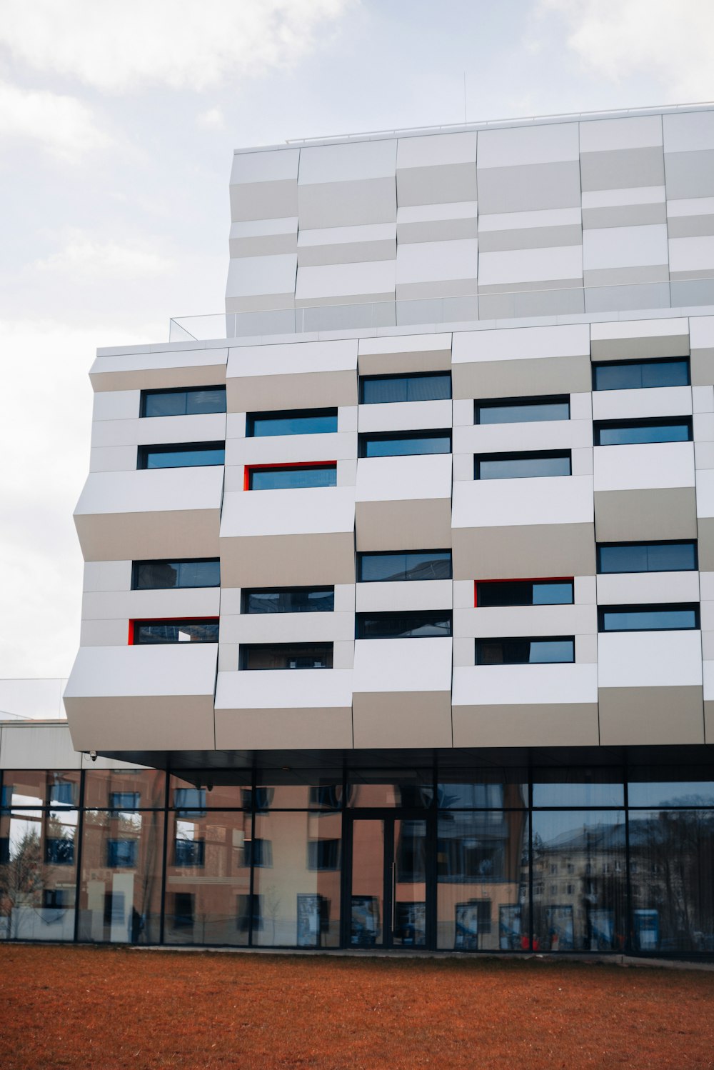 a tall white building with many windows on the side of it