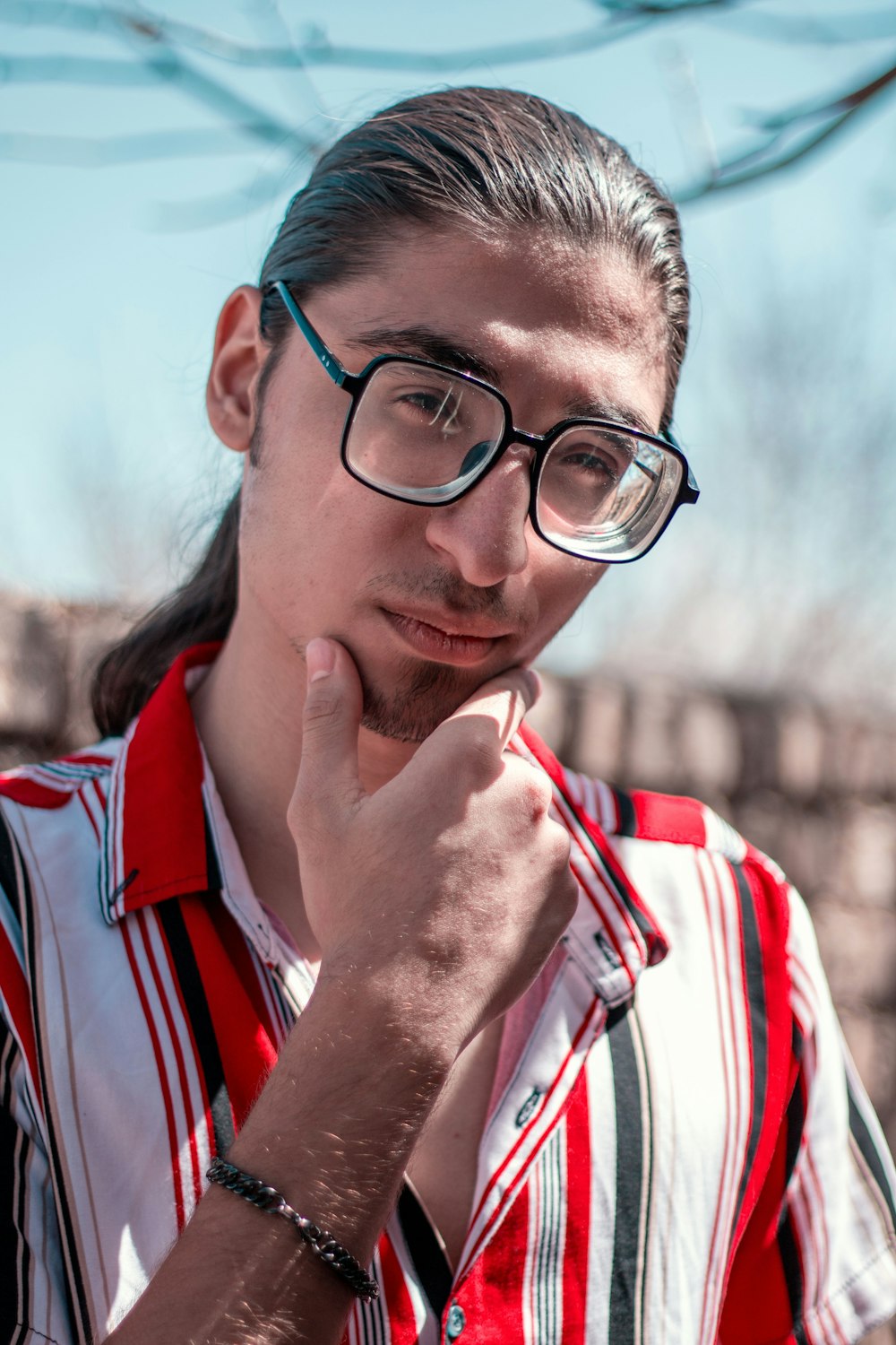 a man wearing glasses and a red and white striped shirt