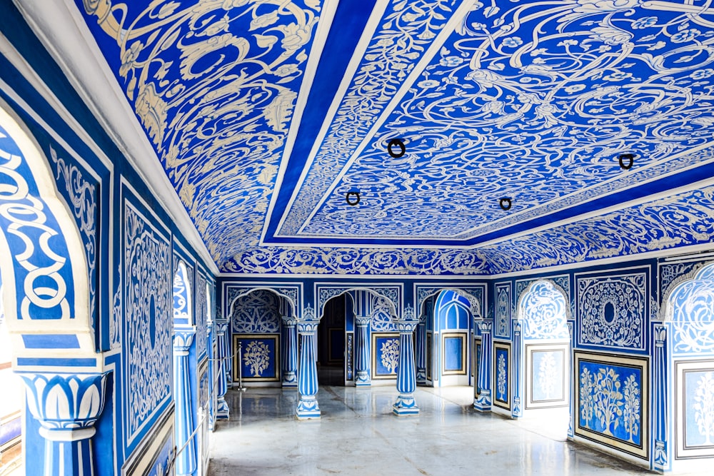 a large room with blue and white designs on the walls