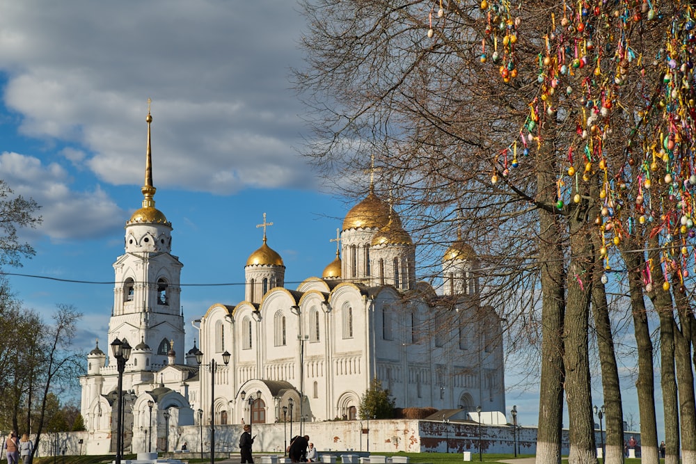 a large white building with gold domes on top of it