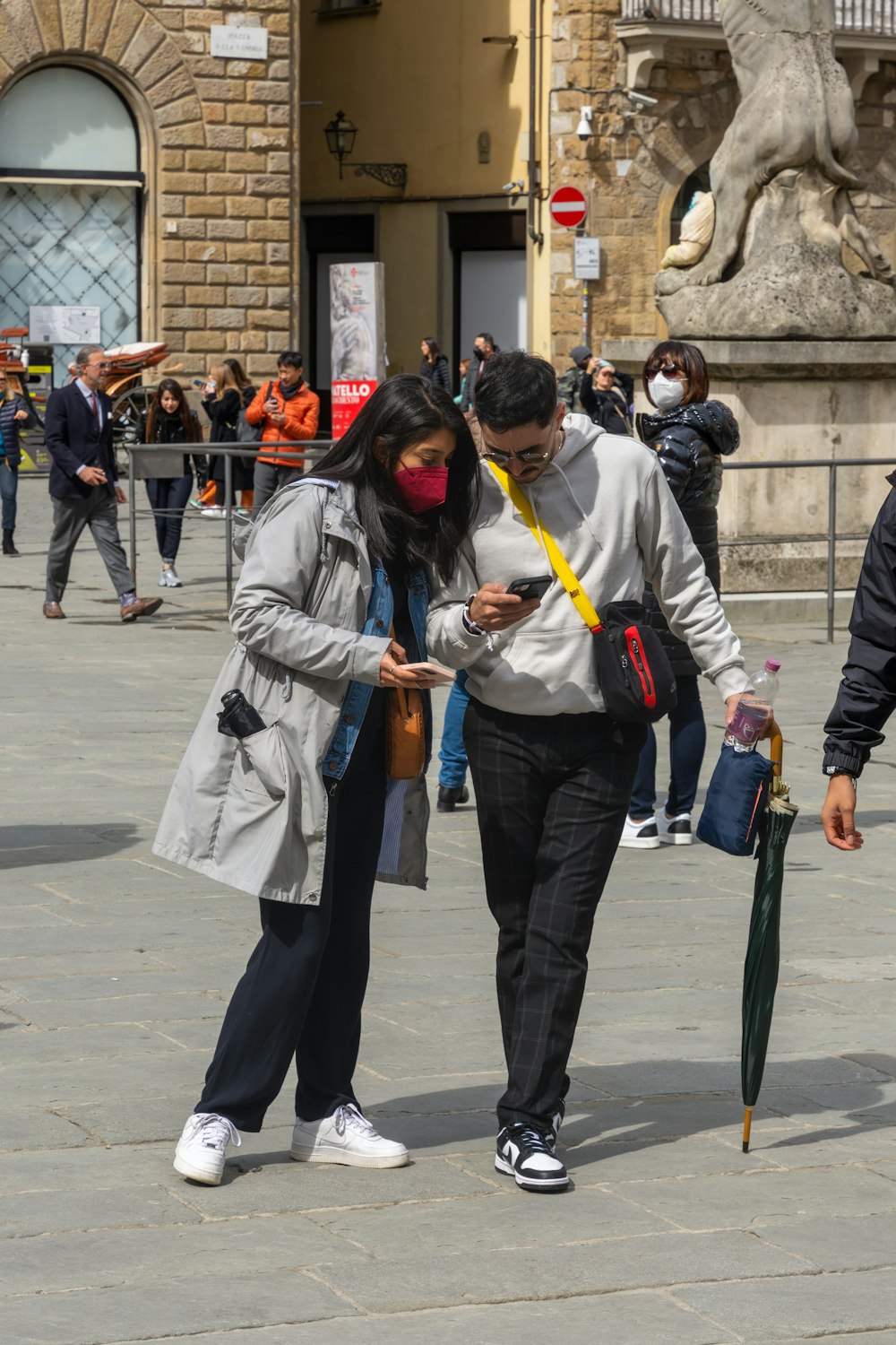 a man and a woman walking down a street