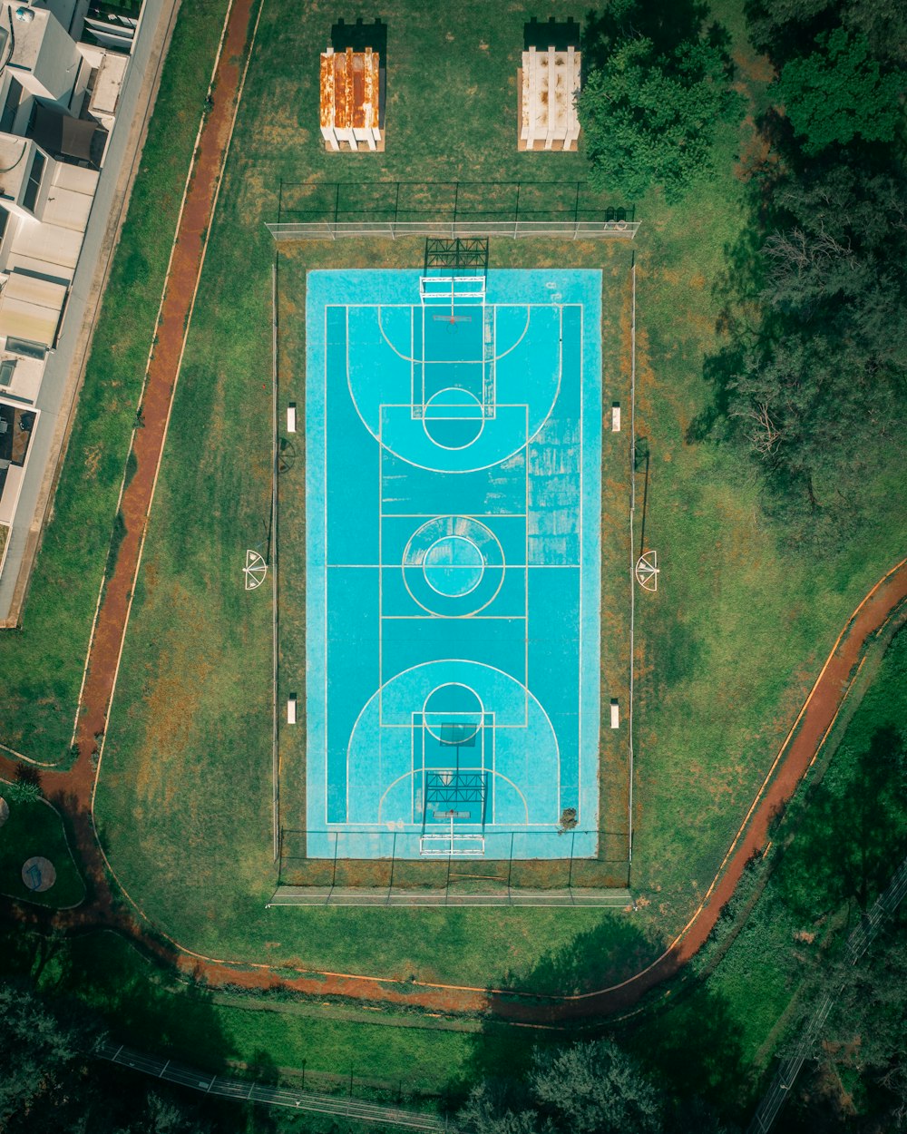 an aerial view of a basketball court in a park