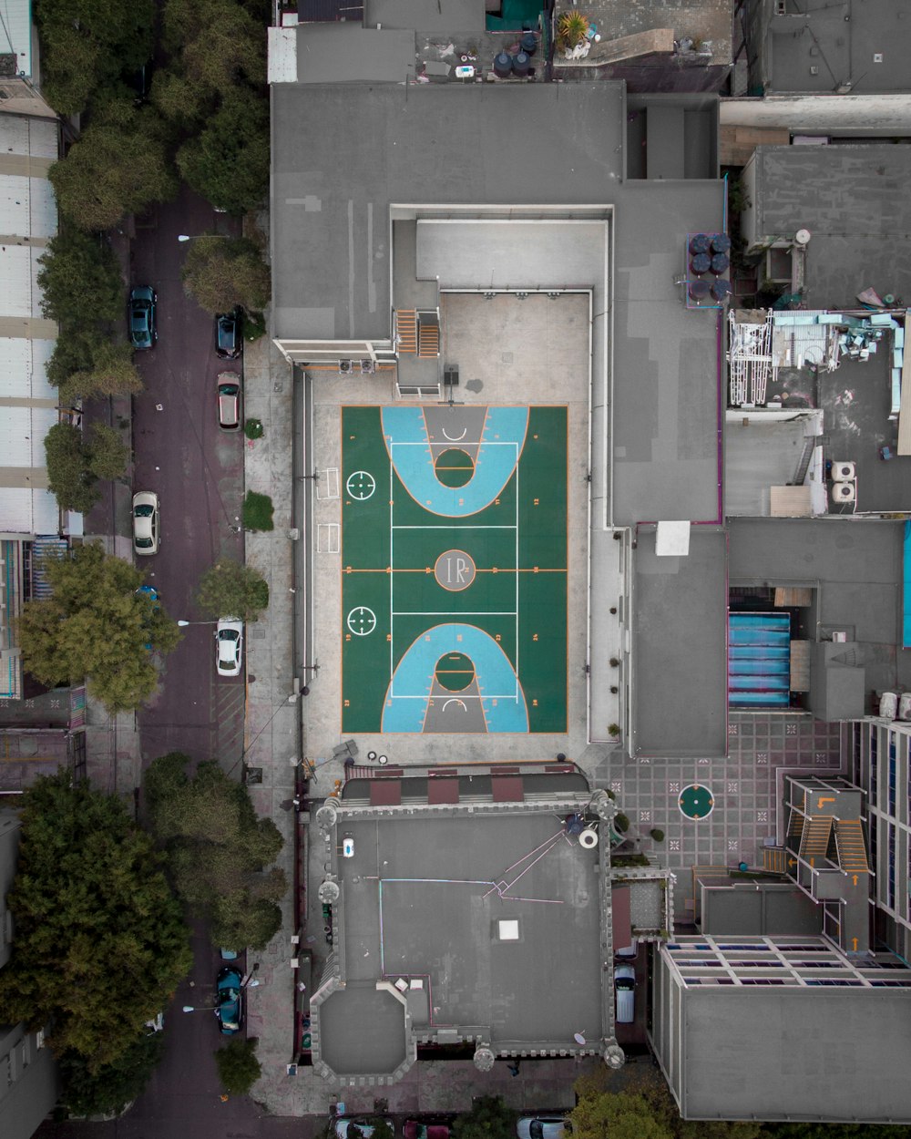 an aerial view of a basketball court in a city