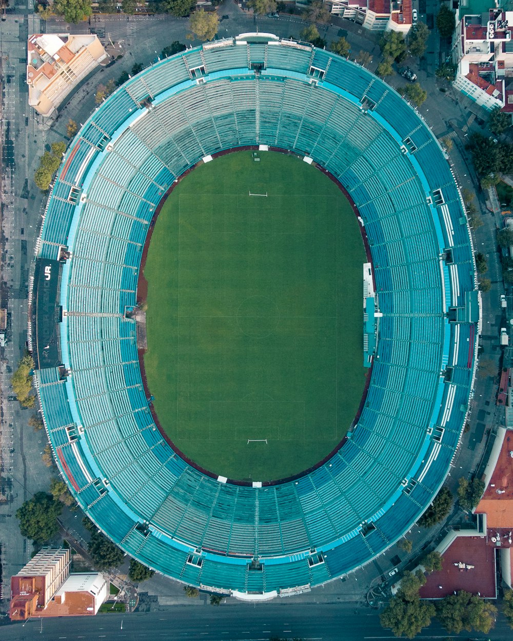 an aerial view of a stadium with a green field