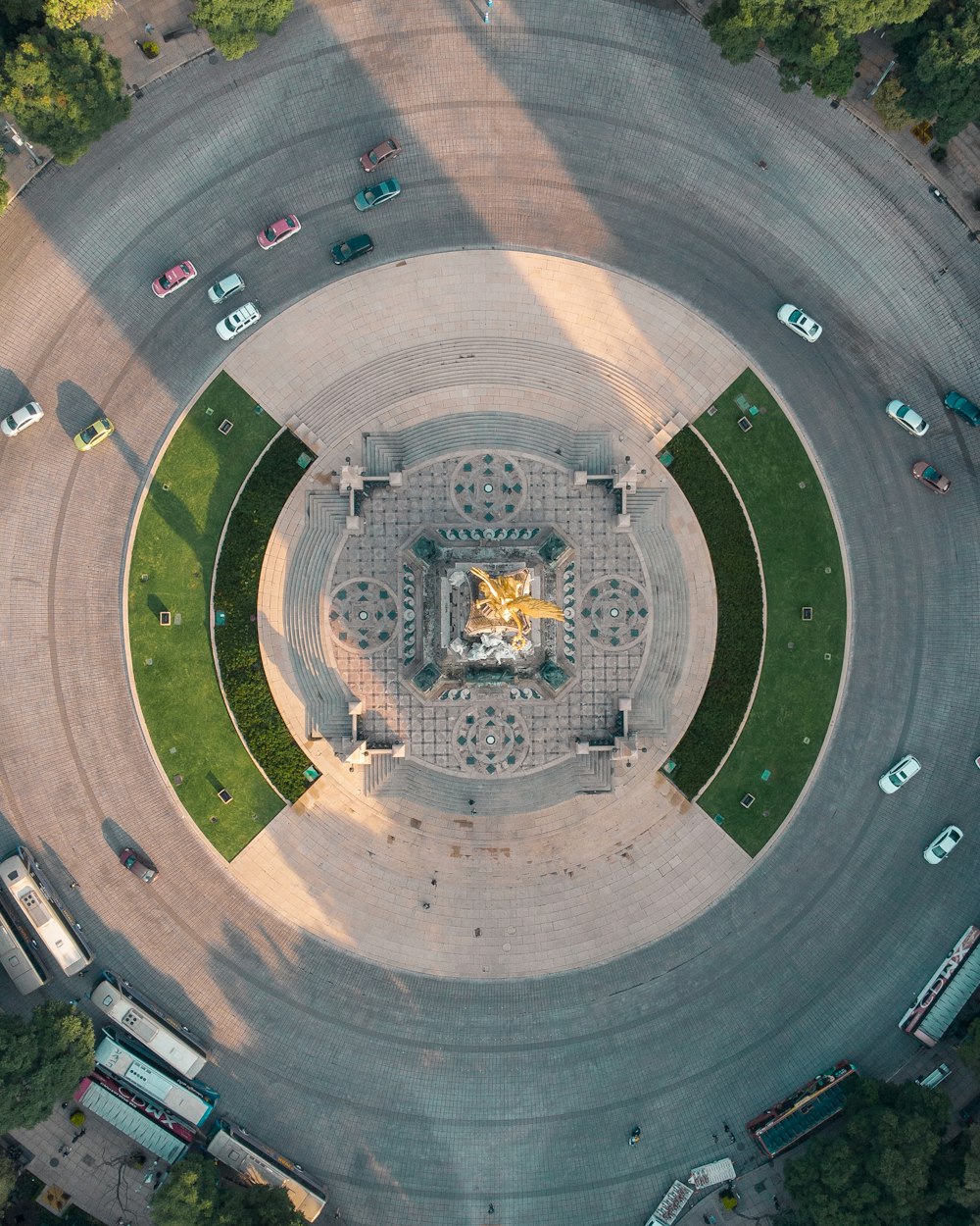 an aerial view of a circular building with a statue in the center