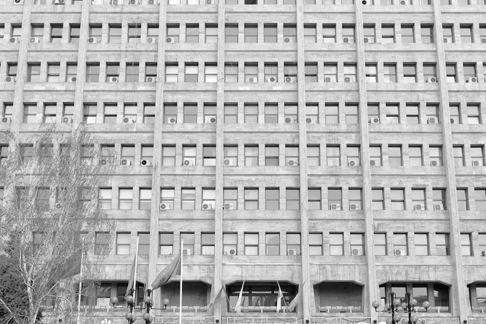 a tall building with lots of windows next to a street