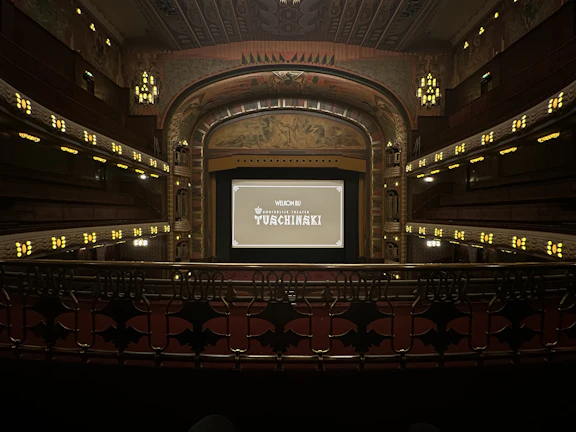 A vibrant movie theater interior blending classic and futuristic design elements.